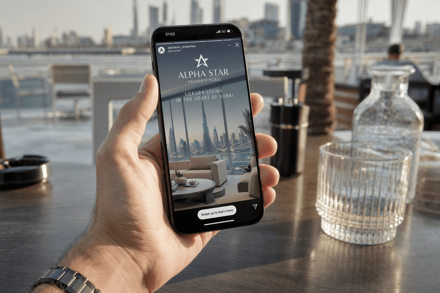 Alpha Star Dubai creative — iPhone Instagram Story ad shown at rooftop cafe